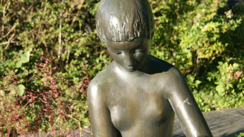 a statue is shown with his head close to the back of his body