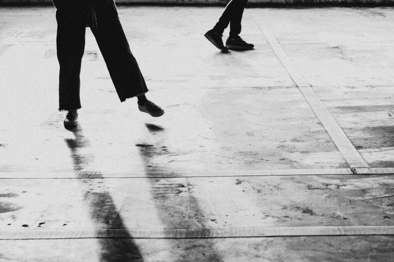 two women with umbrellas standing on the side walk