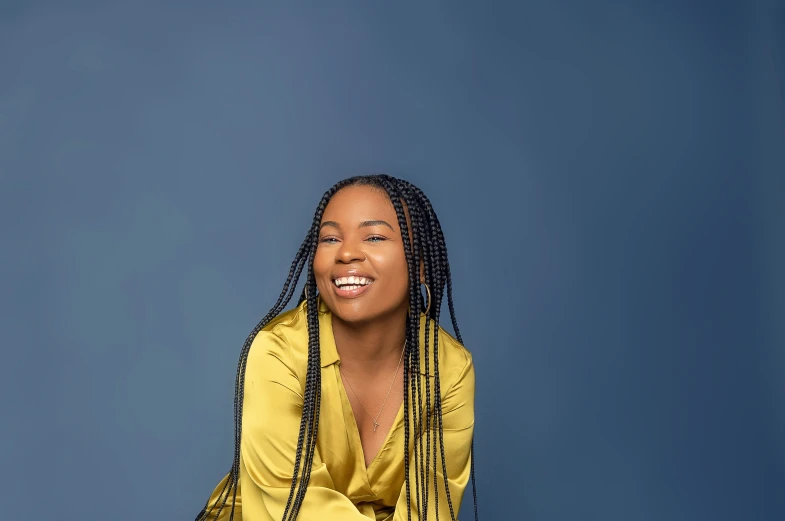 a smiling woman sitting on top of a blue floor