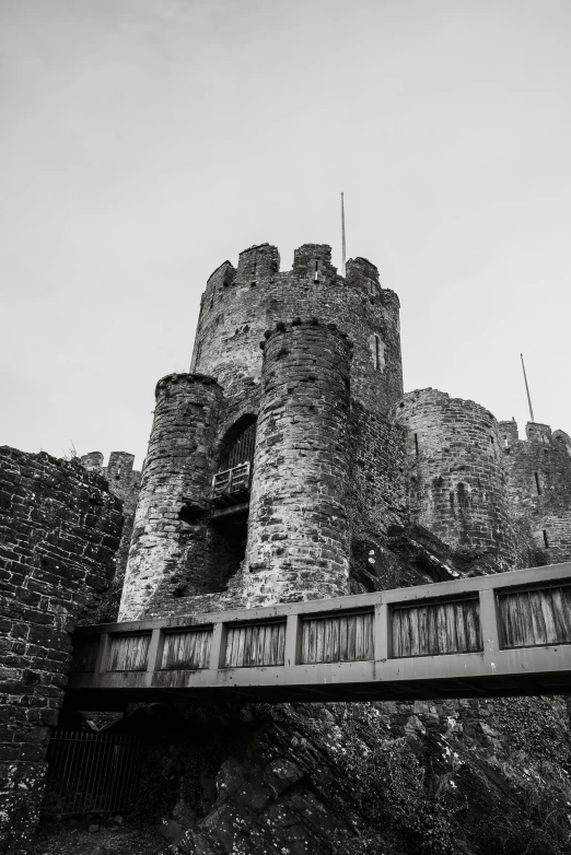 black and white po of a building with a bridge above it