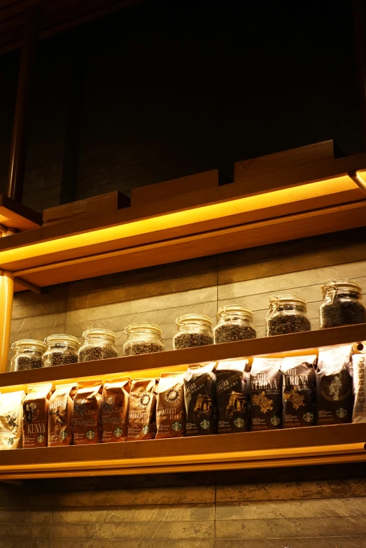 the shelves of jars are filled with different kinds of food