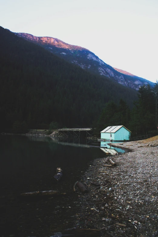 a lake is shown surrounded by a rocky area with a building