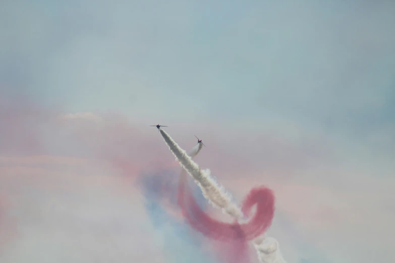 a jet plane soars through the blue sky