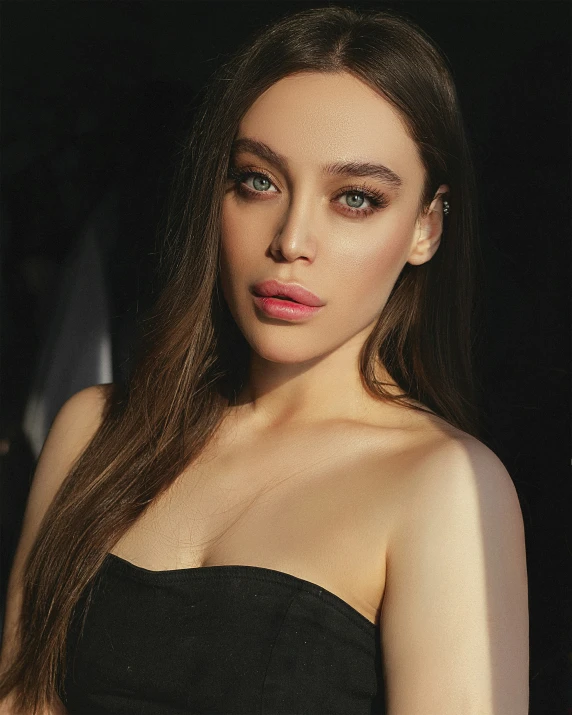 a model poses for the camera in an elegant black dress