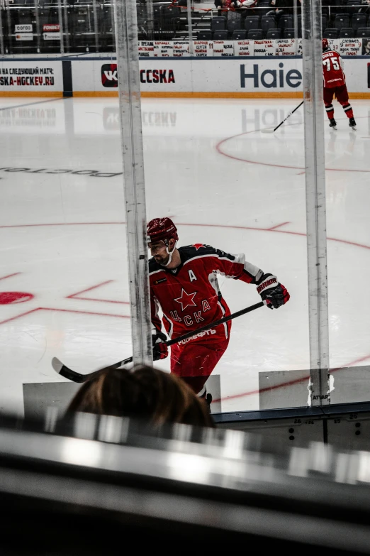 a hockey player is about to come around the net