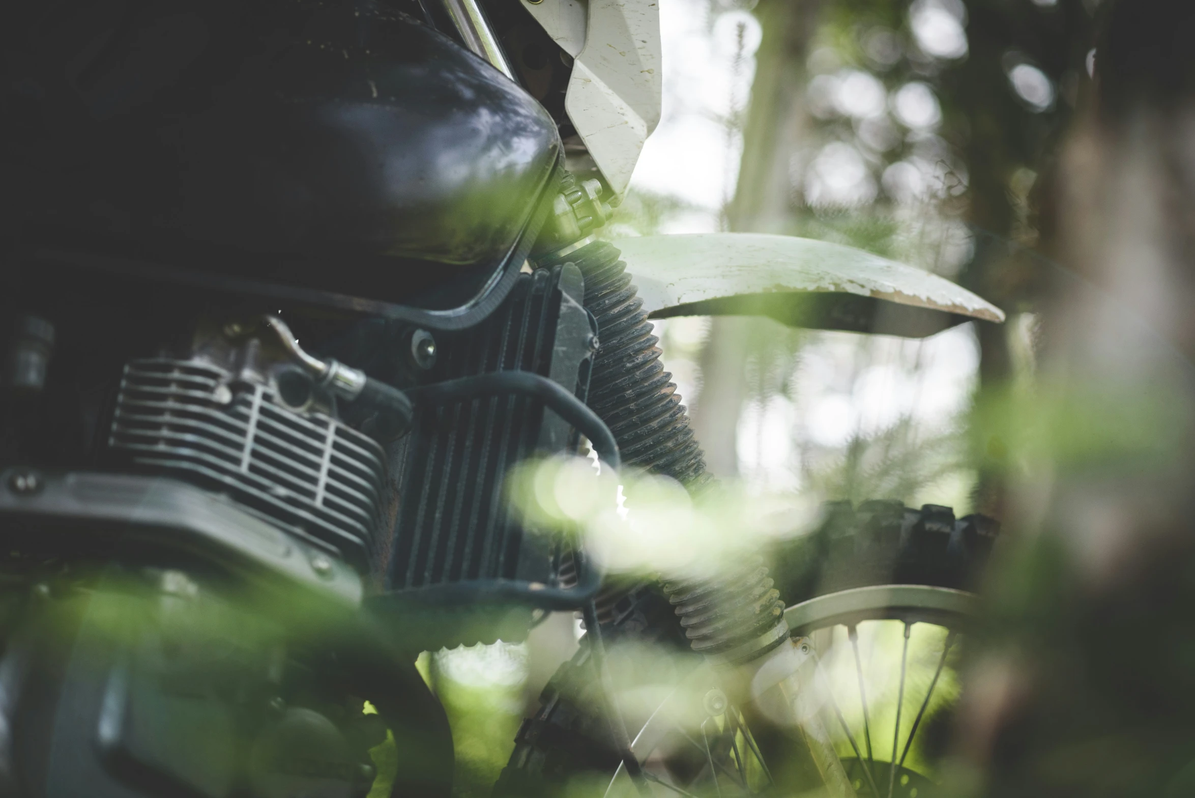 an open motorcycle parked in a forest