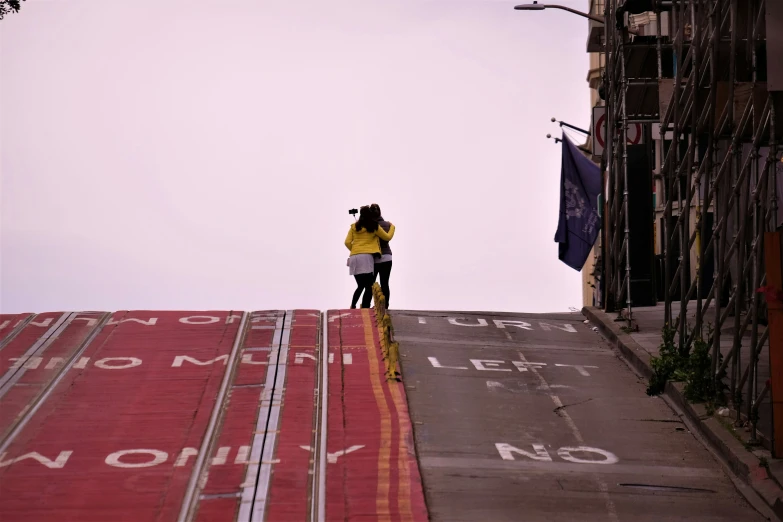 two people on a slope top with no entry sign on it