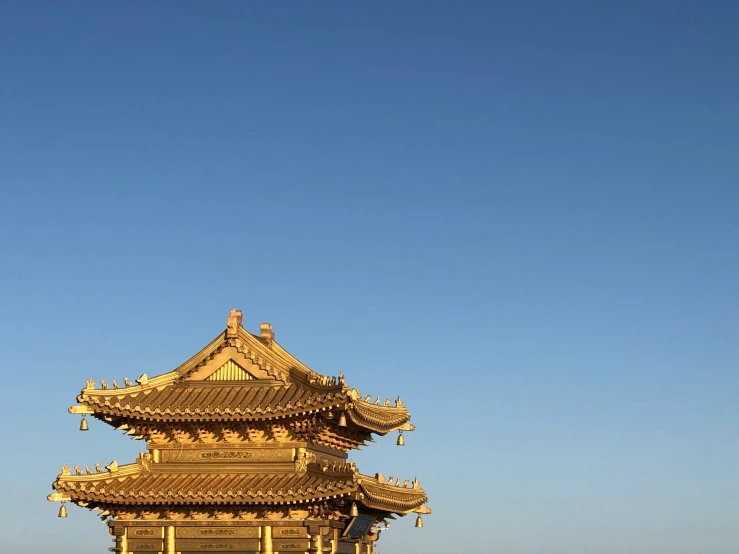 a tall pagoda surrounded by mountains and blue sky