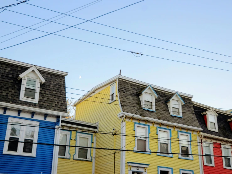 three large multicolored homes with the top level on an angle