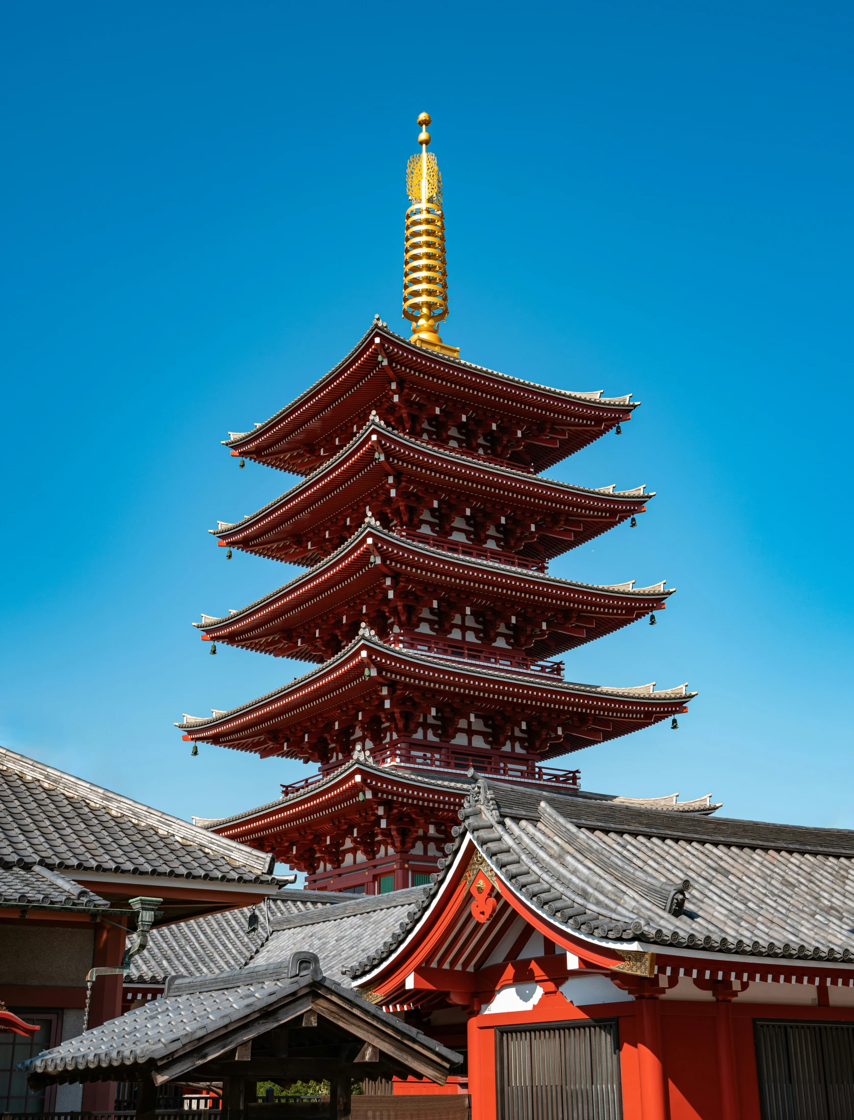 a red building has a tall golden spire