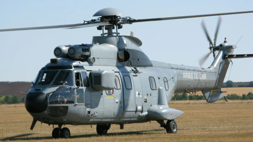 the front and back view of a military style helicopter in a field