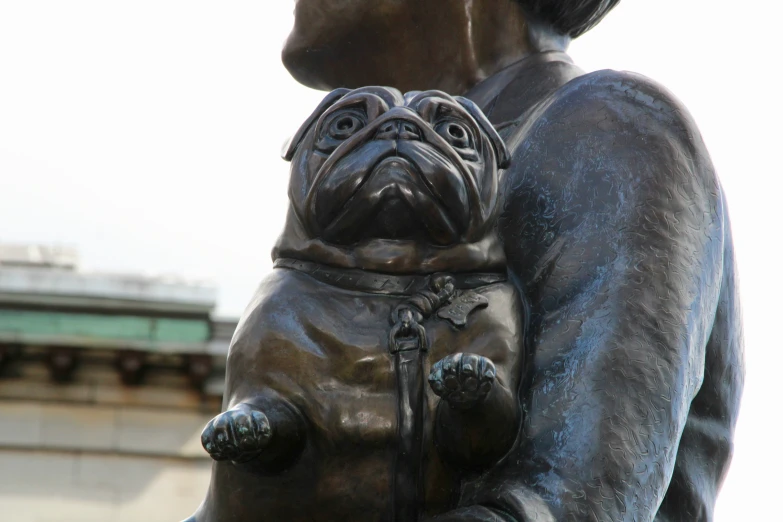 the large bronze statue of a woman with a dog is shown