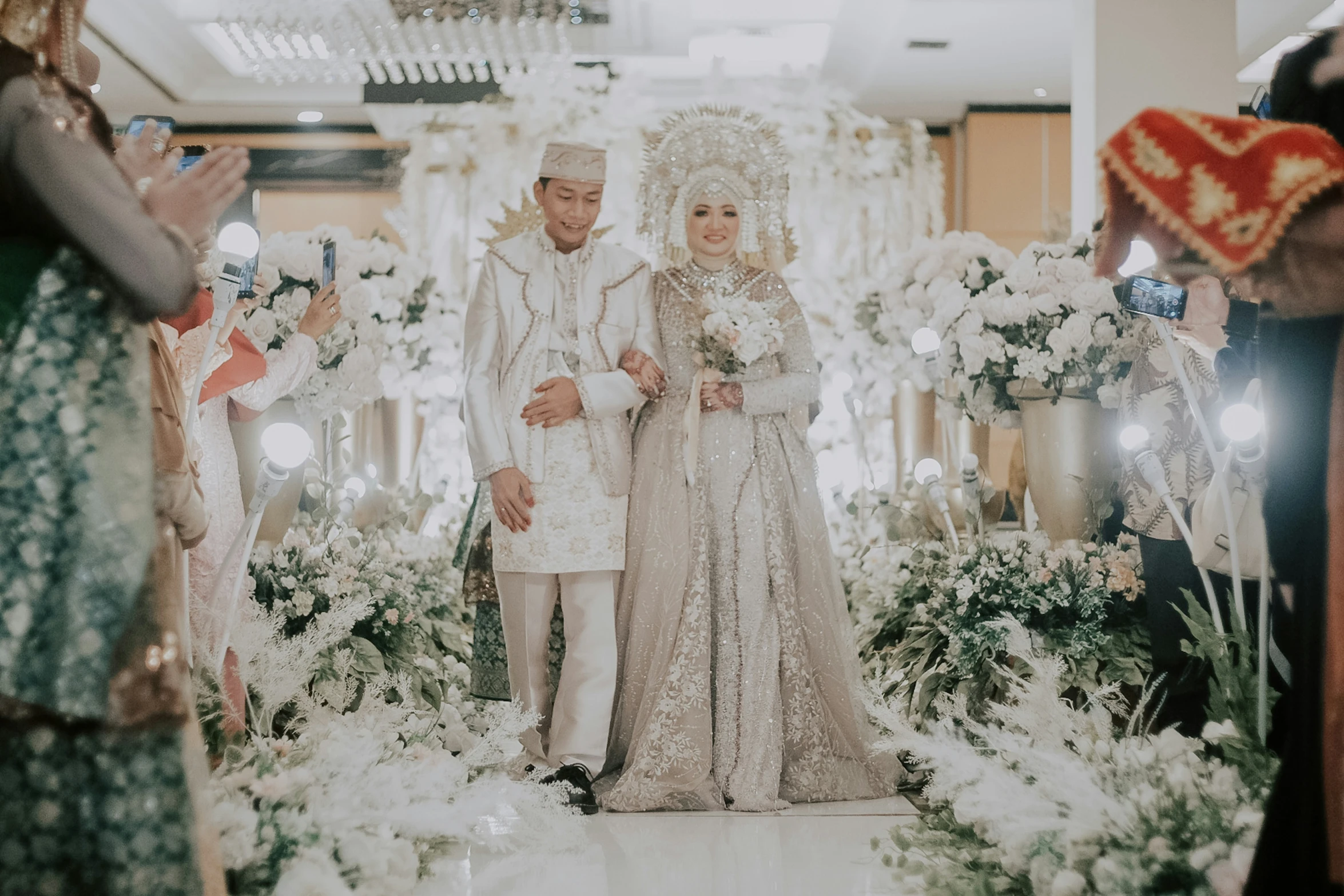 a bride and groom walking down the aisle at their wedding