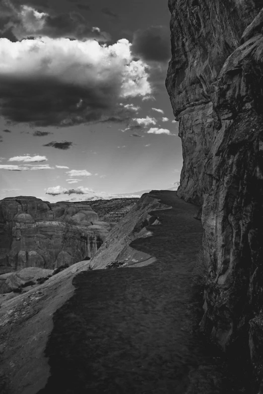 an overcast sky above a canyon, a stream and rocky cliffs