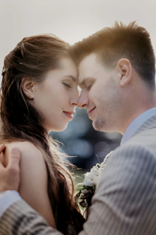 a couple is kissing in front of a building