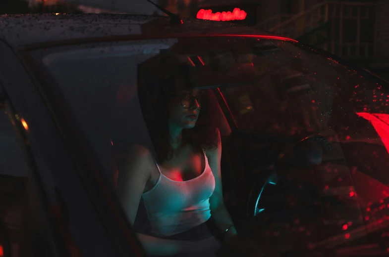 a woman sitting in a car with no  on