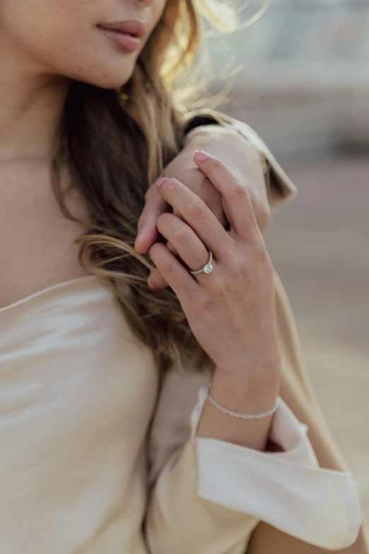 a close up of a woman's hand while wearing a wedding band