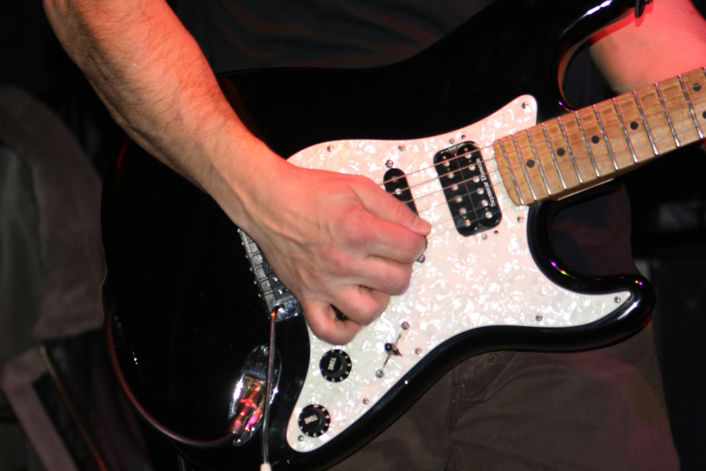 a closeup of a person playing a guitar