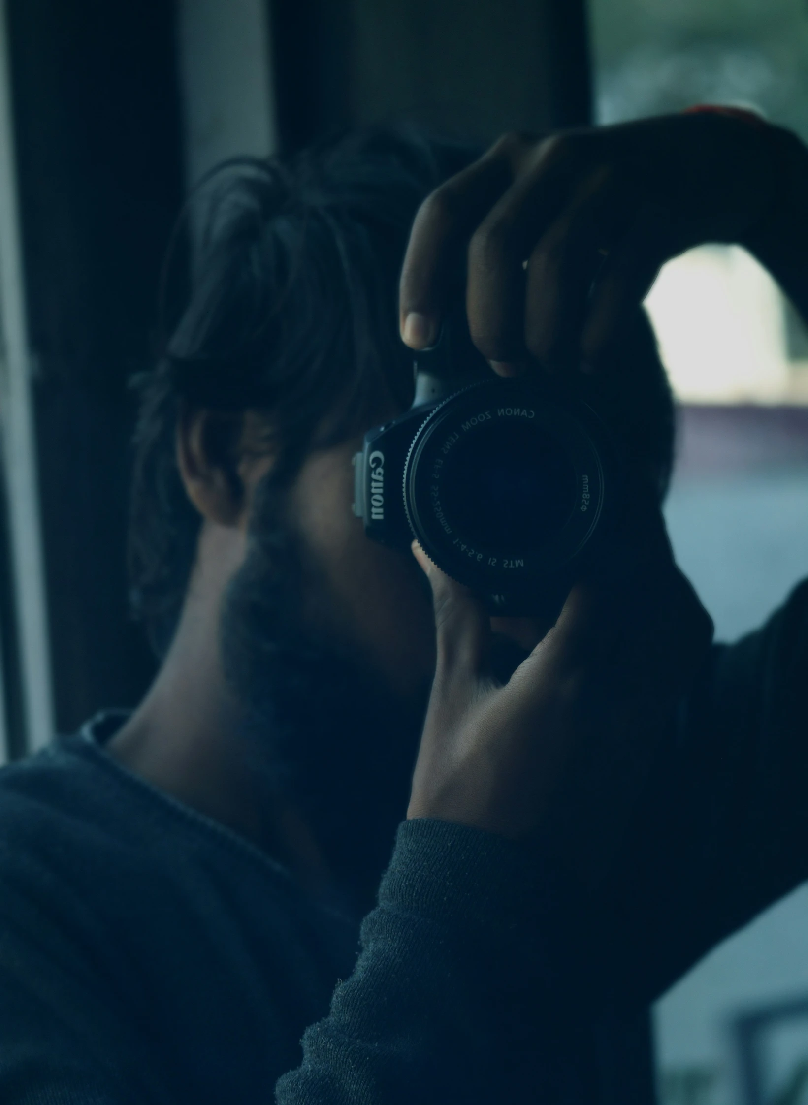 man taking po in mirror in urban area