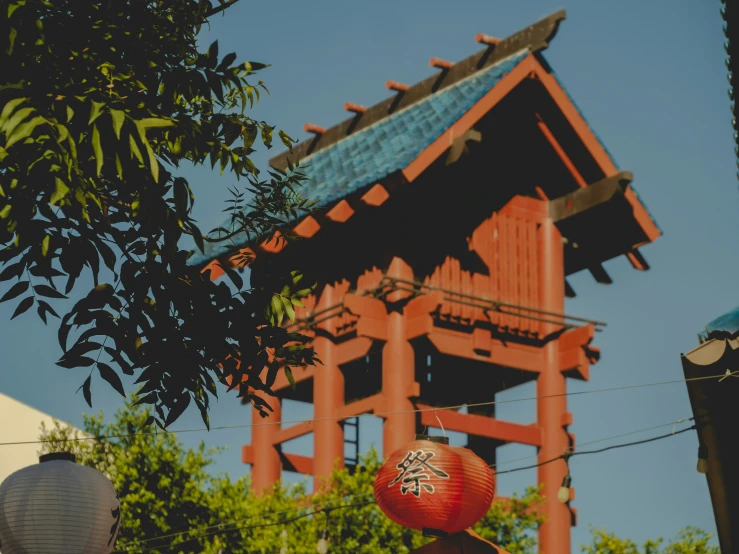 a pagoda tower with an asian lantern hanging above it