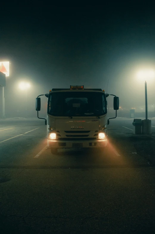 a truck on a street with lights and fog on the street