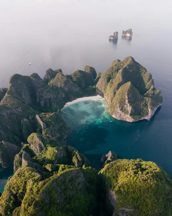 a body of water surrounded by green mountains