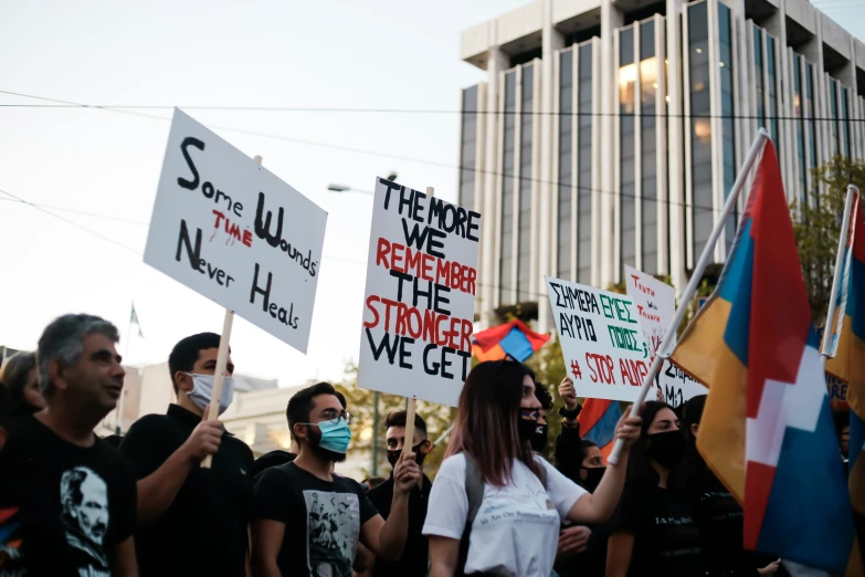 people in a street holding signs with words that read save the climate