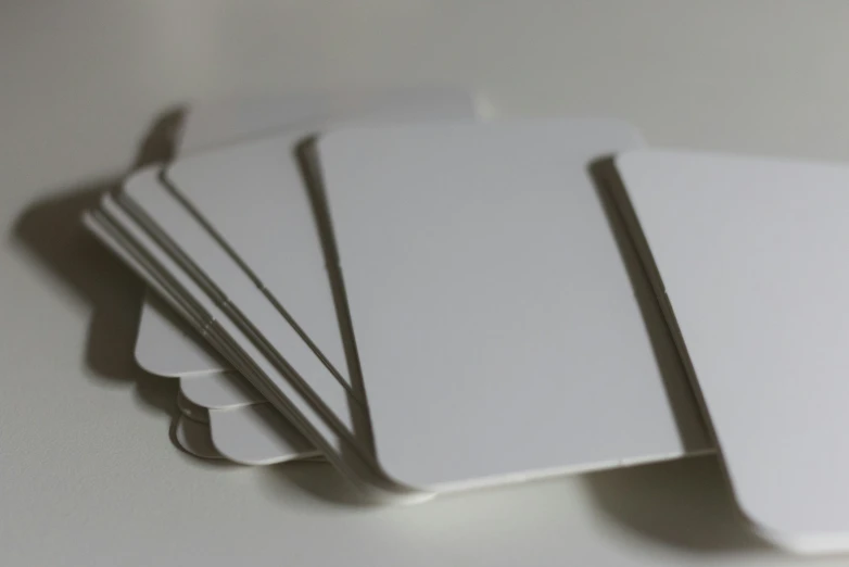 several blank cards with grey edges lie together
