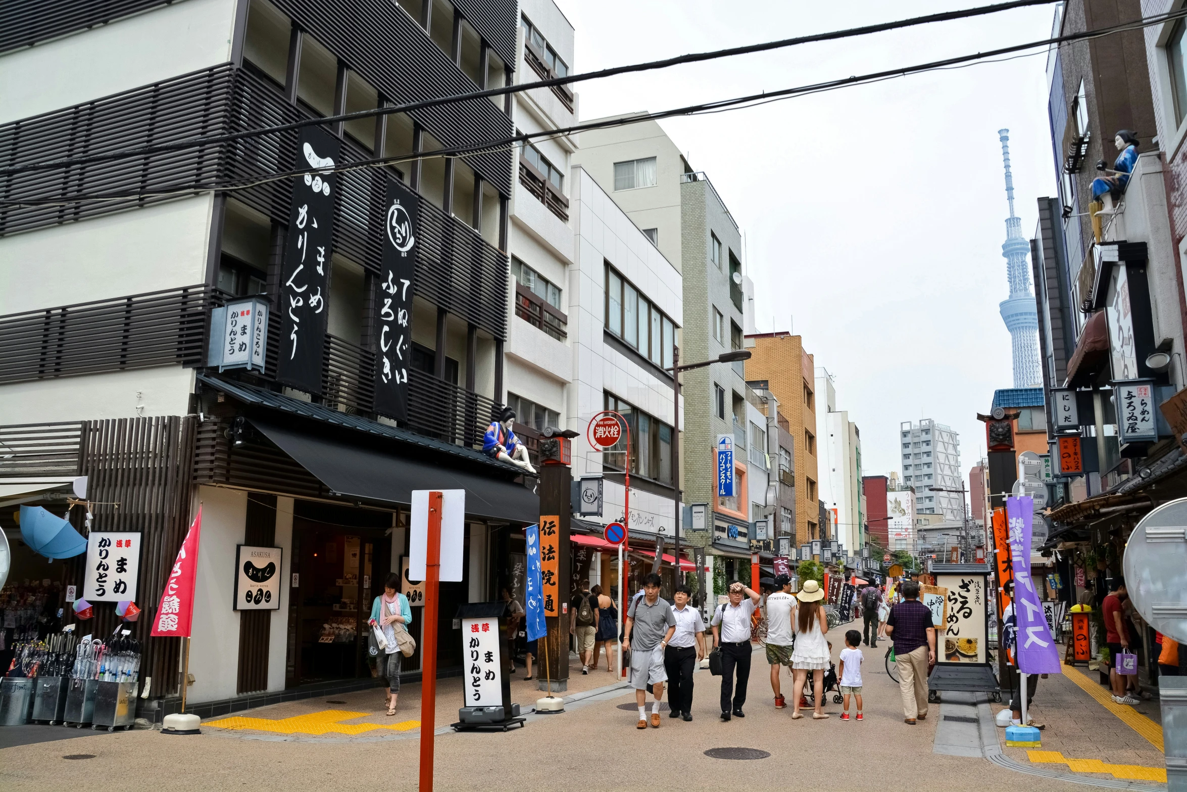 people walk down the street of a city in an urban setting