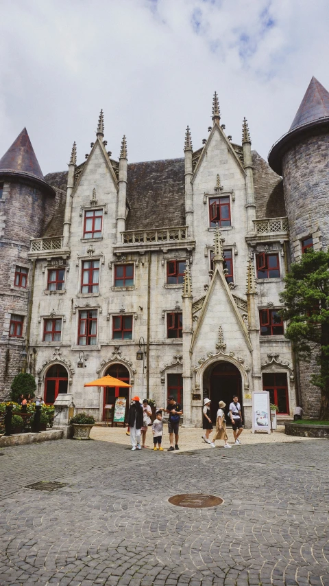 people are standing outside of the large building