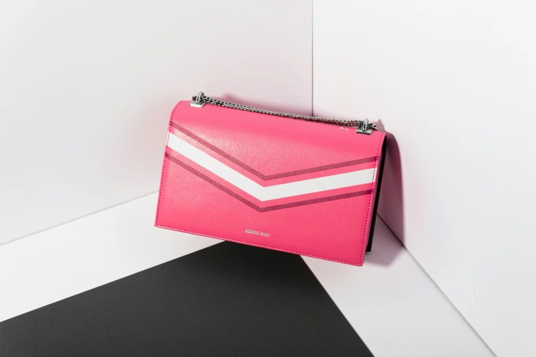a pink handbag with white and black accents
