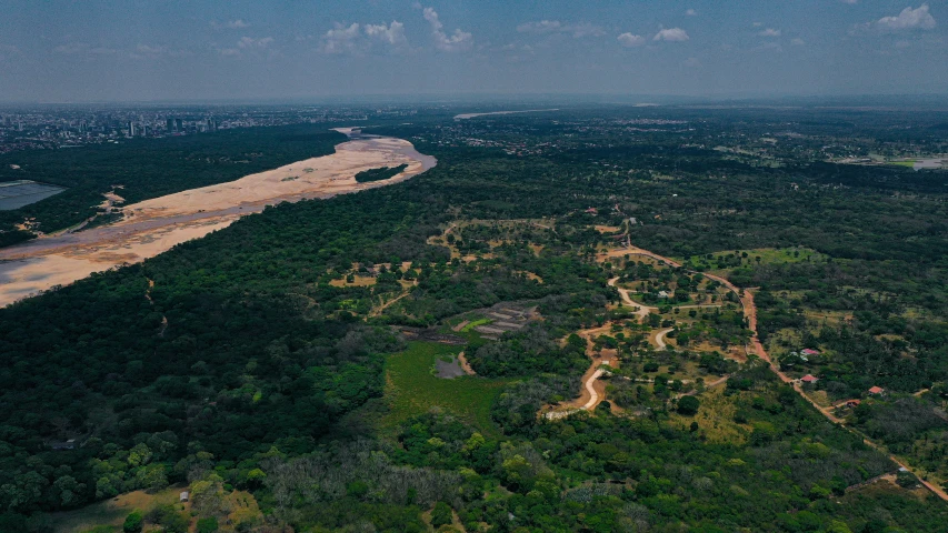 a aerial view of an empty river and forested area