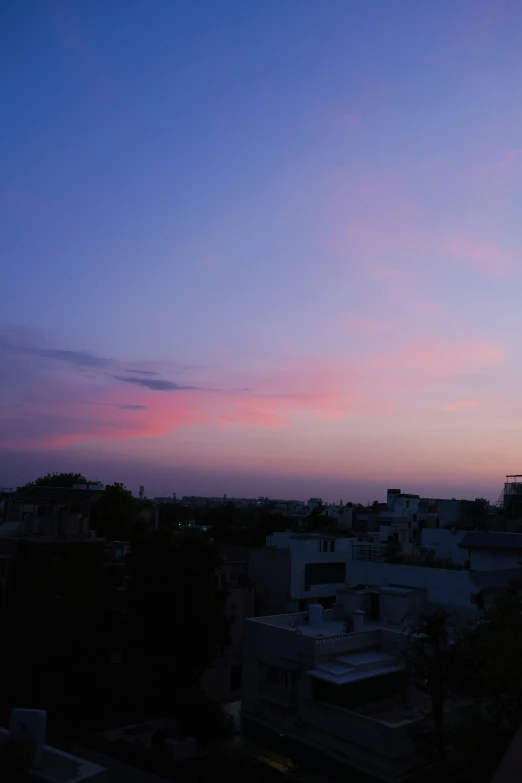 the sunset or sunrise seen from a rooftop top of a building