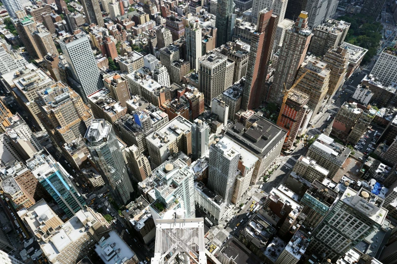 an aerial view of city with skyscrs and cars