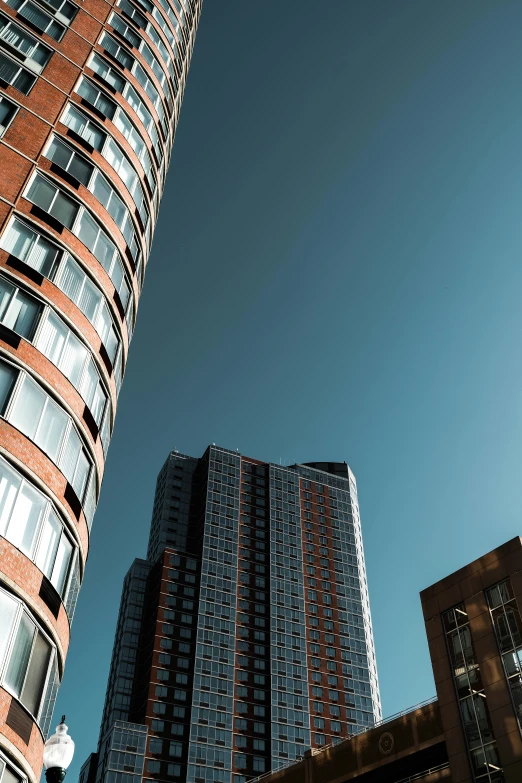 two tall buildings in front of a clear blue sky