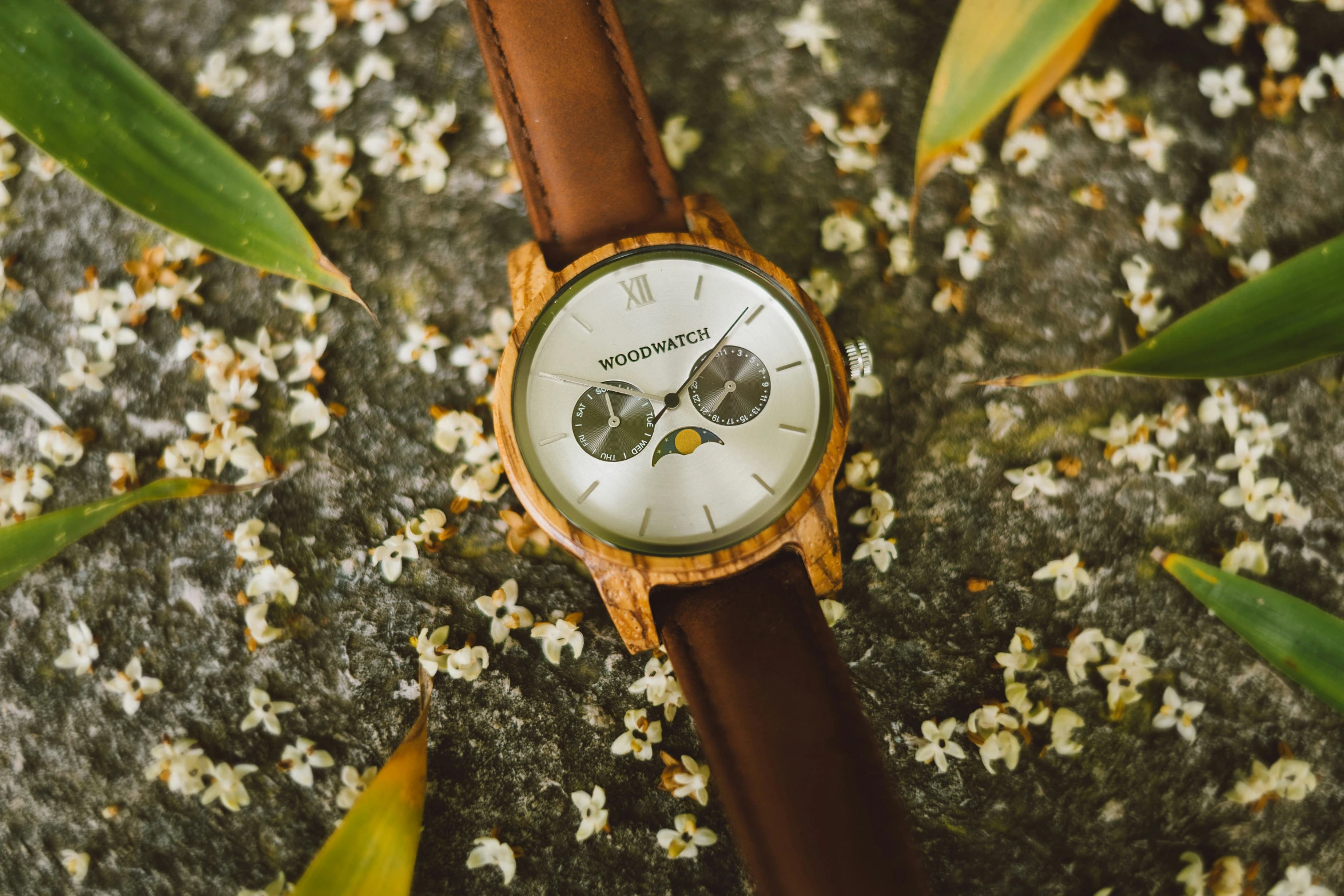 an antique looking wooden watch with white face