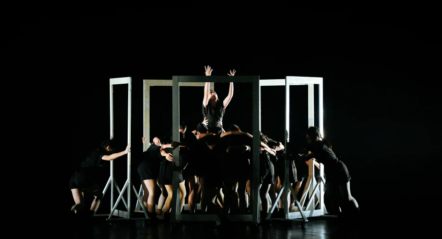 a group of people are standing around a stage