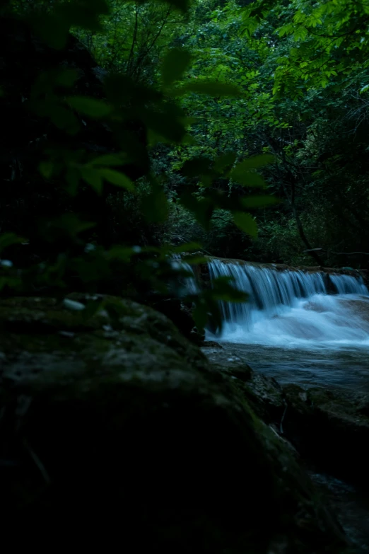 a stream of water that is running over rocks