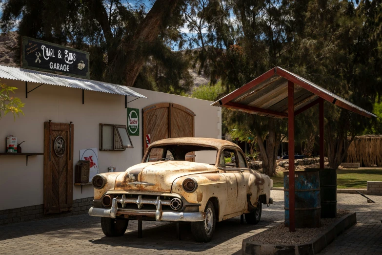 an old fashioned car parked outside a store