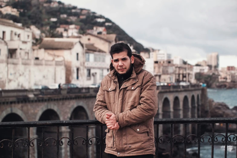 the young man is standing on the balcony