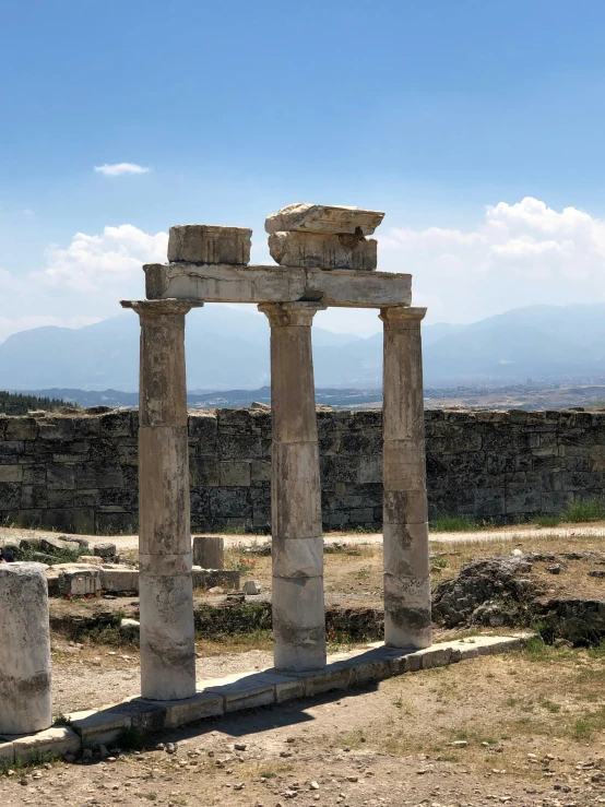 an ancient monument that stands alone on a sunny day