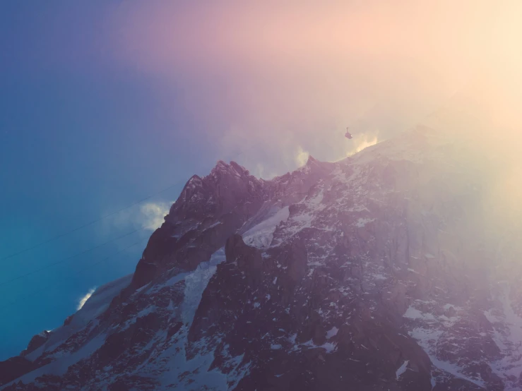 mountains are covered in snow, with some clouds