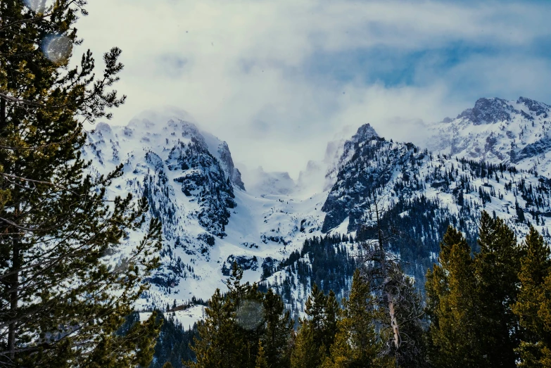 mountains with a few snow capped tops in the woods