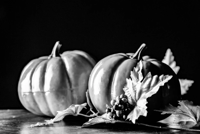 two pumpkins sit together next to each other