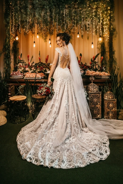 the back of a brides dress looks like it has a bouquet hanging from it