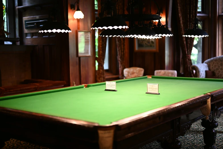 a large green pool table inside of a room