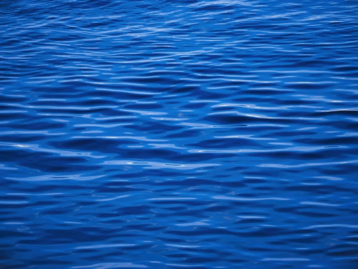 a blue background with ripples and lines in the water