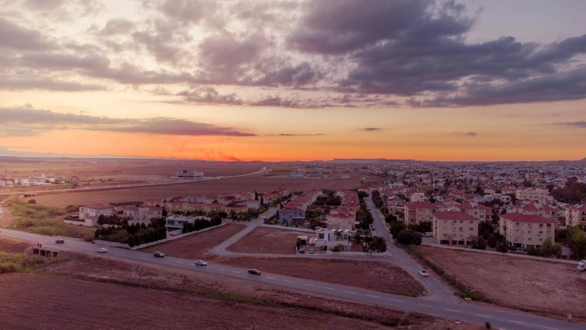 a town that is standing next to a large field