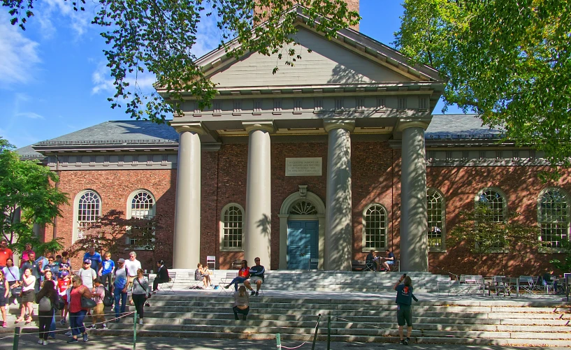 people are standing around in front of a brick building