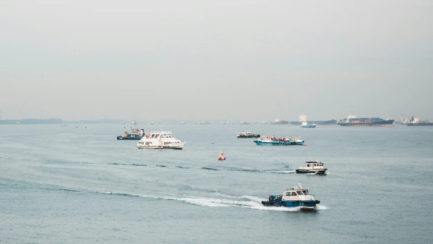 several different boats are traveling across the water